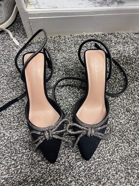 BCBG Black Pointed-Toe Strappy Heels with Rhinestone Bow